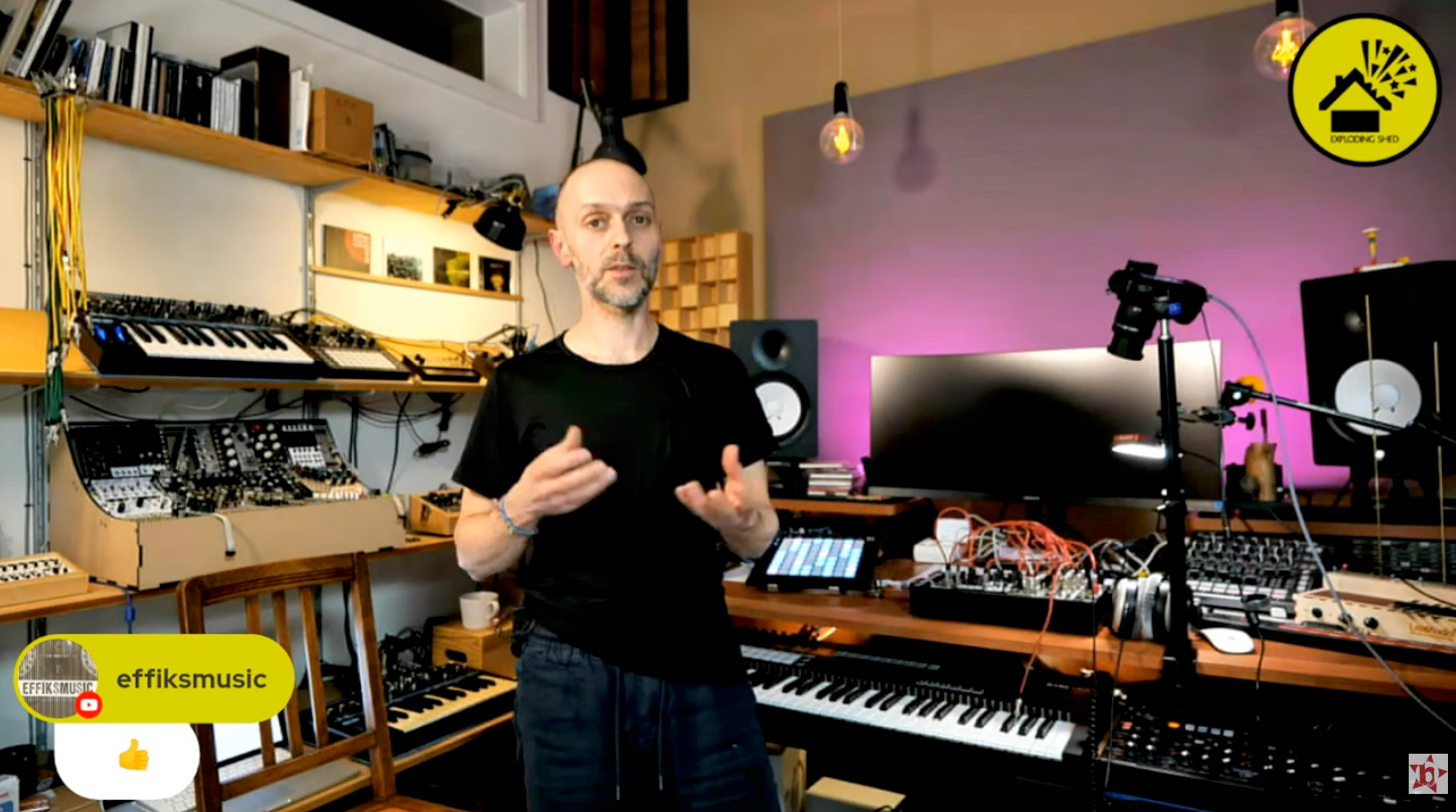 Still from an Exploding Shed online workshop: the instructor explains in his studio, surrounded by synthesizers and modular systems